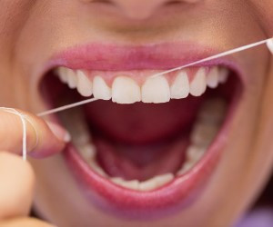 female-patient-flossing-her-teeth_107420-65468